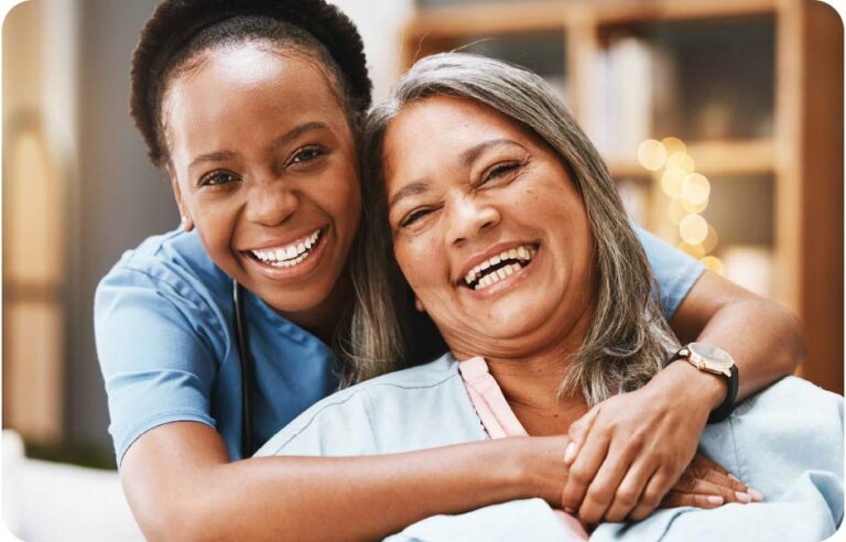 Two smiling female caregivers at Focus on Freedom.